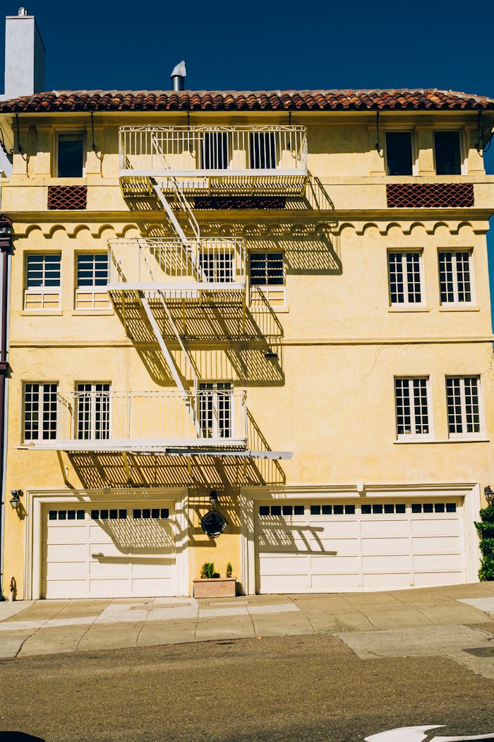 Historic urban apartment building with distinct fire escape and sunny facade.